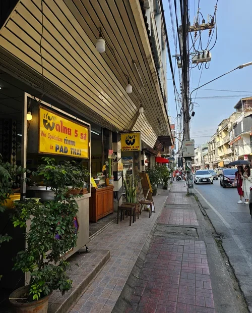 노란 간판의 팟타이 전문점이 있는 태국 거리 풍경