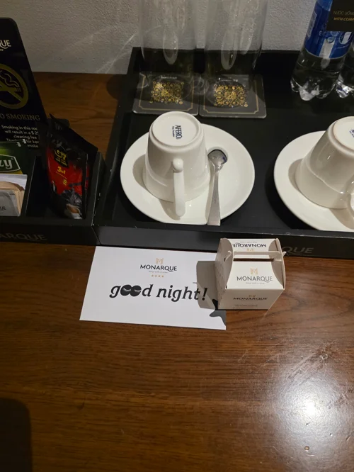 사이드 테이블 위 굿나잇 카드와 모나크 티 세트가 담긴 웰컴 서비스