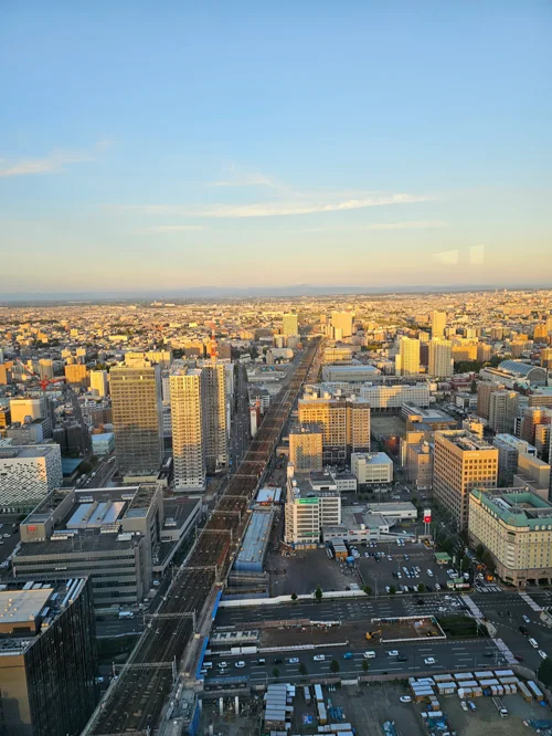 석양빛에 물든 삿포로 도심 전경과 중앙의 철도 선로